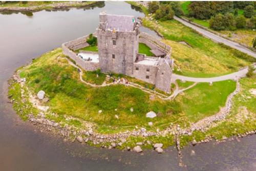 an old castle on an island in the water at Burren Nature Sanctuary Apartment in Galway