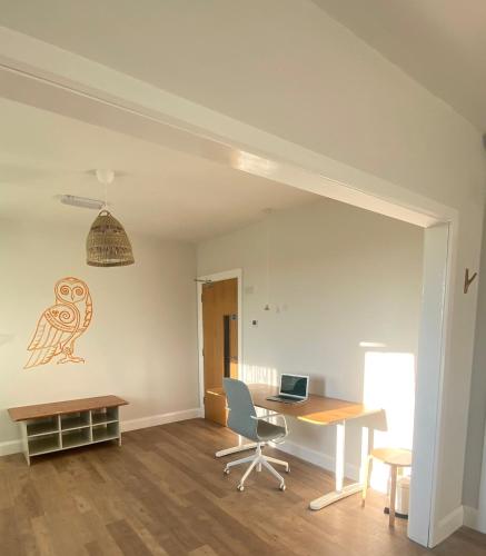 an office with a desk and a laptop on a wall at Burren Nature Sanctuary Apartment in Galway