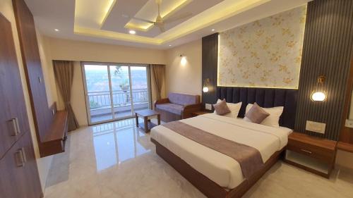 a hotel room with a bed and a window at The Mountain Paradise Mahabaleshwar in Kelghar