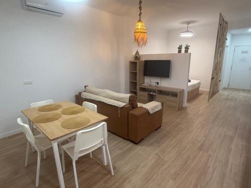 a living room with a table and a couch at guadiaro studio in Málaga