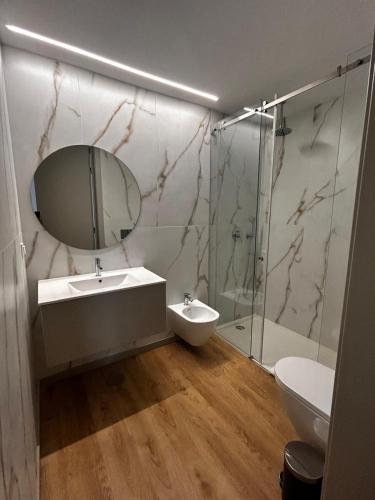 a bathroom with a sink and a mirror and a shower at NEW Douro 901 Mezzanini with parking in Vila Nova de Gaia