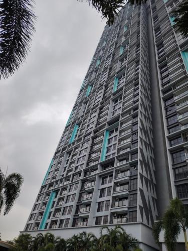 a tall building with palm trees in front of it at Trion KL Residence by Skyline in Kuala Lumpur