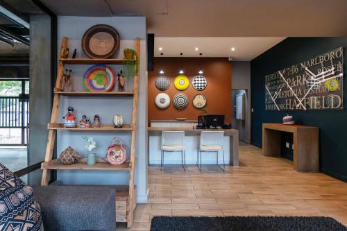 a room with a table and chairs and a counter at Akanani Apartments in Pretoria