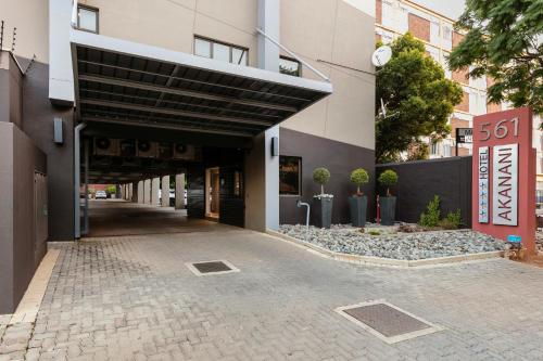a building with a black awning over a street at Akanani Apartments in Pretoria