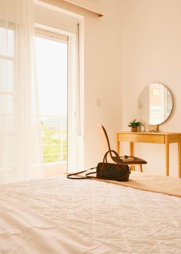 a bedroom with a bed and a mirror and a desk at Villa Anastasia in Apolakkiá