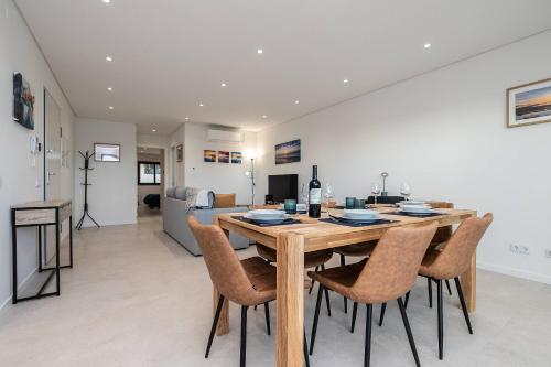a dining room and living room with a table and chairs at Sunset View Apartment in Conceicao de Tavira in Tavira