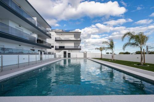 an external view of a building with a swimming pool at Sunset View Apartment in Conceicao de Tavira in Tavira
