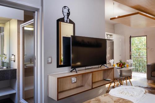 a living room with a flat screen tv on a wall at Akanani Apartments in Pretoria