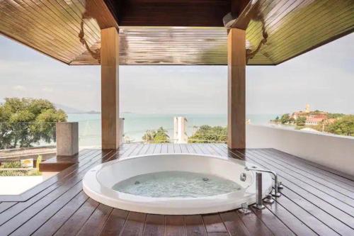 a bath tub in a room with a view of the ocean at Thai Villa Melitta Bangrak Bohput, Beach, Pool, SeaViews, 6-enSuite, Full Villa, Luxury, AAA Location Koh Samui in Bang Rak Beach