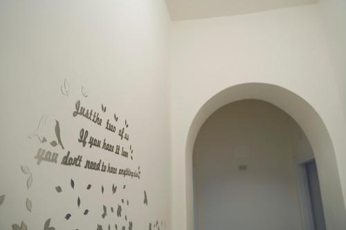 a hallway with an archway and a wall with letters at La Stazione Sabina Alloggio Turistico in Stimigliano