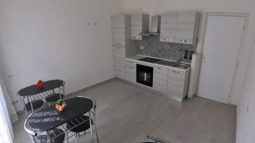 a kitchen with two chairs and a table in it at La Stazione Sabina Alloggio Turistico in Stimigliano