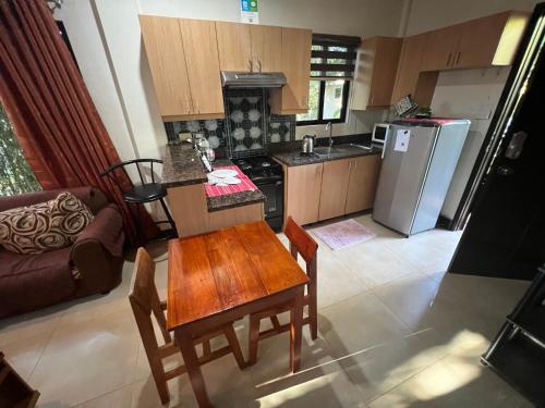 a kitchen with a table and chairs and a refrigerator at Adayo Cove Resort in Siquijor