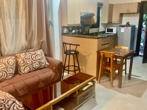 a living room with a couch and a kitchen at Adayo Cove Resort in Siquijor
