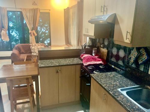 a kitchen with a sink and a stove top oven at Adayo Cove Resort in Siquijor