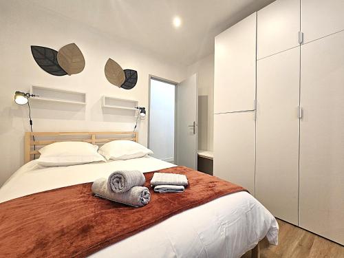 une chambre avec un lit avec des serviettes dessus dans l'établissement Le Sarrail - Appartement 2 à 4 personnes - 1 chambre double séparée - 5 min à pied de la gare et centre ville, à Montauban