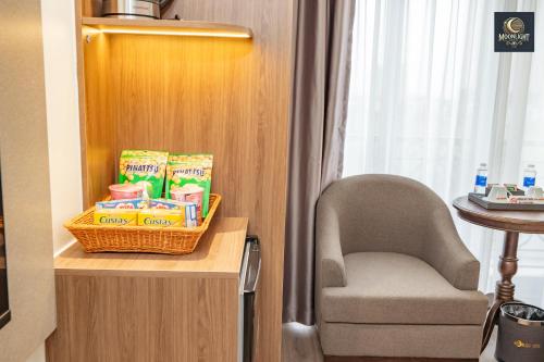 a room with a chair and a basket of snacks at Khách sạn MoonLight An Khánh Hà Nội in Vân Lũng