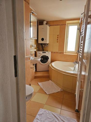 a bathroom with a tub and a sink and a toilet at Apartmán u Martina in Poprad