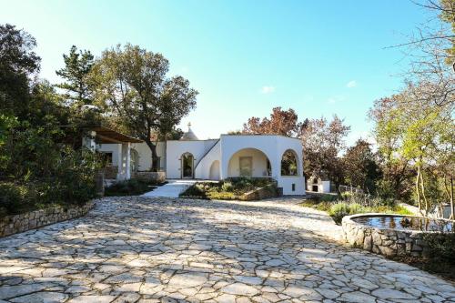 a house with a stone driveway at Villa Leonardo Luxury Locorotondo in Locorotondo