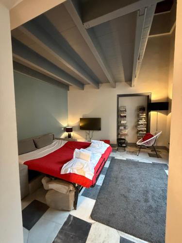 a bedroom with a large bed with a red blanket at Palazzo Cambiaso Albergo Etico Genova in Genova