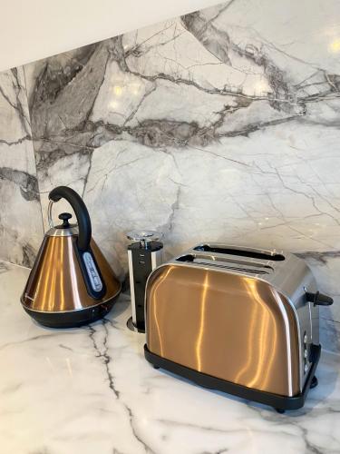 a toaster and a tea kettle on a counter at Kaoglen - Alpine Pod - Hot Tub - Cairngorms - Pitlochry in Kirkmichael