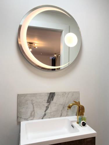 a bathroom with a sink and a mirror on the wall at Kaoglen - Alpine Pod - Hot Tub - Cairngorms - Pitlochry in Kirkmichael