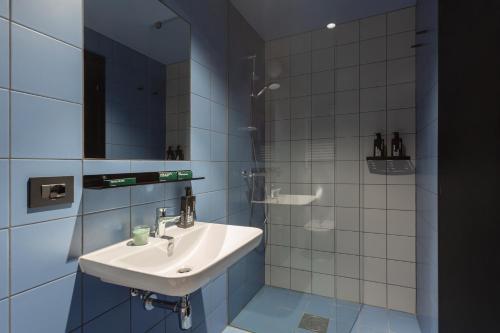 a bathroom with a sink and a mirror at CX Milan NoM in Milan