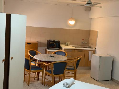 a kitchen with a table and chairs in a kitchen at The St. George’s Park Hotel in St. Julianʼs