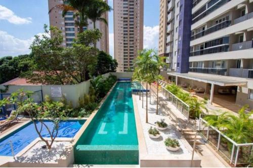 an image of a swimming pool in a building at Conforto e lazer na rua do hospital Albert Einstein! in Goiânia