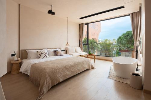 Ένα ή περισσότερα κρεβάτια σε δωμάτιο στο Xiamen Littoral Villa