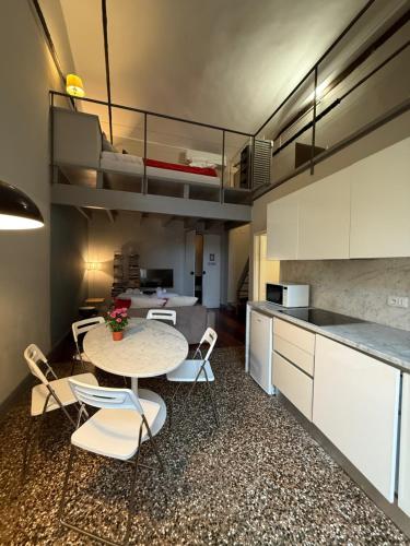 a kitchen with a table and chairs in a room at Palazzo Cambiaso Albergo Etico Genova in Genova