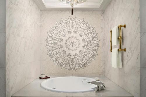 a bathroom with a tub and a mandala on the wall at The St. Regis on the Bund, Shanghai in Shanghai