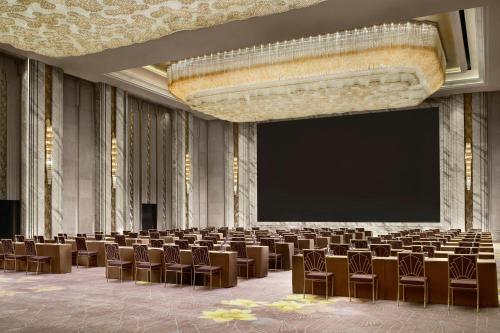 a large room with chairs and a projection screen at The St. Regis on the Bund, Shanghai in Shanghai