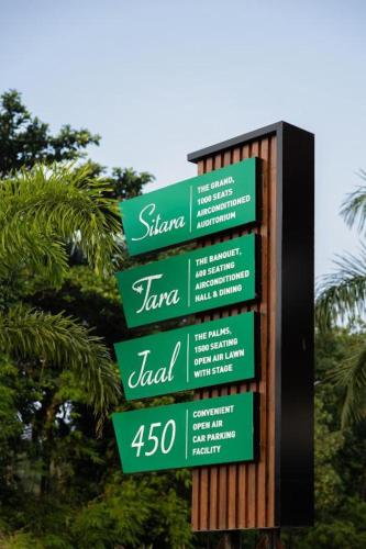 a sign with green and white signs on it at Premier Greens in Mūlki