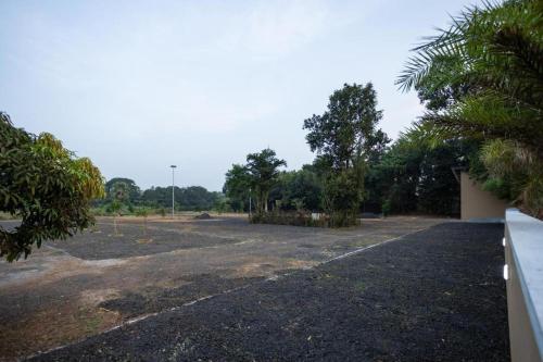 an empty parking lot with trees in the background at Premier Greens in Mūlki