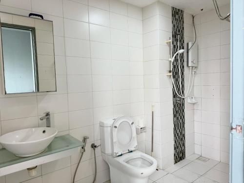 a bathroom with a toilet and a sink at Rainforest City House Paradigm Skudai UTM TVBox in Johor Bahru