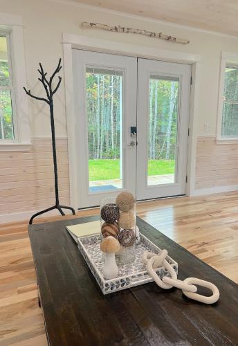 a room with a table with some items on it at Newly Built Retreat in the Woods Near Acadia in Trenton