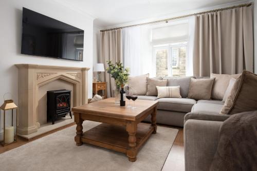 a living room with a couch and a fireplace at Beautiful Alnwick Apartment Two in Alnwick