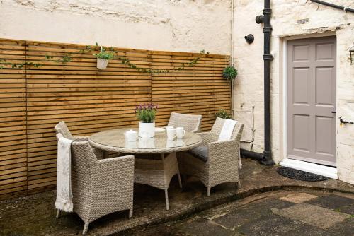 a table and chairs sitting on a patio at Beautiful Alnwick Apartment Two in Alnwick