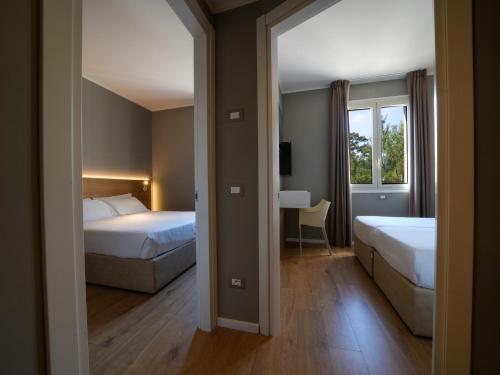 Postel nebo postele na pokoji v ubytování Hotel Club Lacona