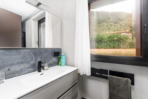 a bathroom with a sink and a window at VOMAN Luxury Apartments in Pietrasanta