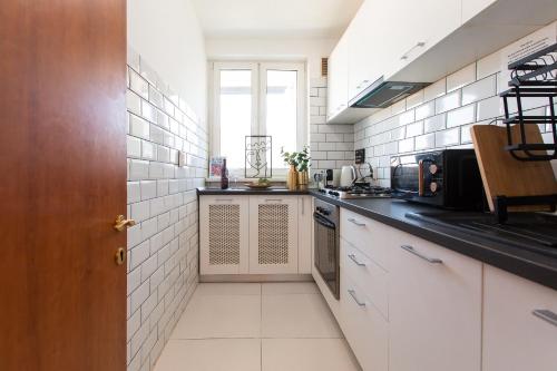 una piccola cucina con piastrelle bianche sul muro di Old Town apartment with Amazing View from the Balcony a Bucarest
