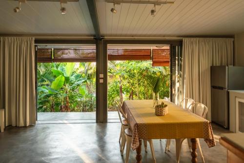 a dining room with a table with a yellow table cloth at Le Jardin d'Antoinette in Rivière Noire