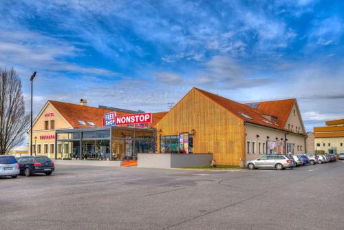 a large building with cars parked in a parking lot at Itvv in Chvalovice