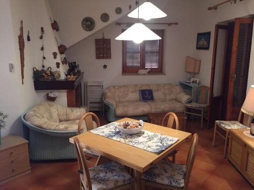 a living room with a table and a couch at Beautiful sea front beach in Granitola
