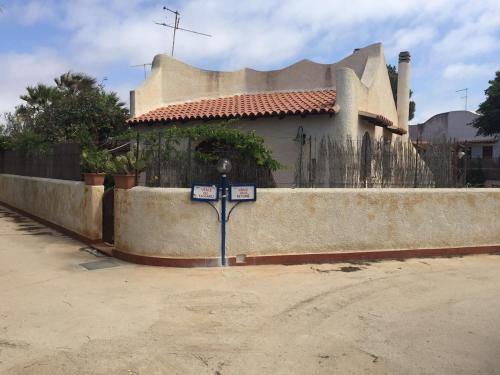 a house with a fence in front of it at Beautiful sea front beach in Granitola
