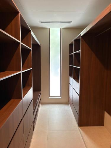 a walk in closet with wooden shelves and a window at Luxury Exclusive Villa in Playa del Carmen