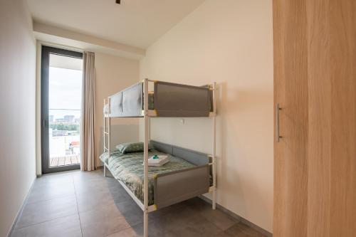 a bunk bed in a room with a window at Luxurious new apartment with stunning views in Ostend