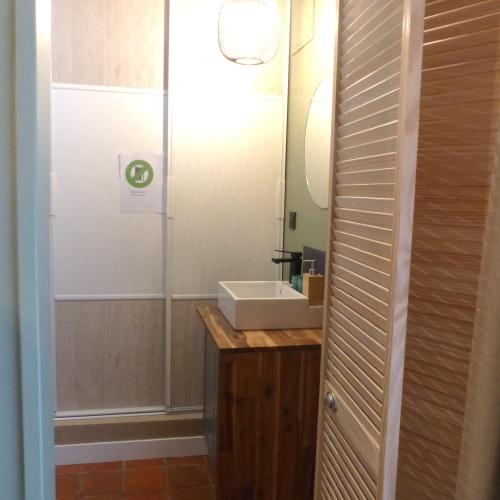 a bathroom with a sink and a mirror at Maison d'hôtes KerCalow, Chambres d'hôtes in Pleine-Fougères