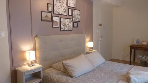 a bedroom with a bed with two tables and two lamps at Maison d'hôtes KerCalow, Chambres d'hôtes in Pleine-Fougères