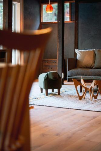 a living room with a couch and a chair at 紡舎 - BO-SHA - - 古民家一棟貸しVilla in Akiruno